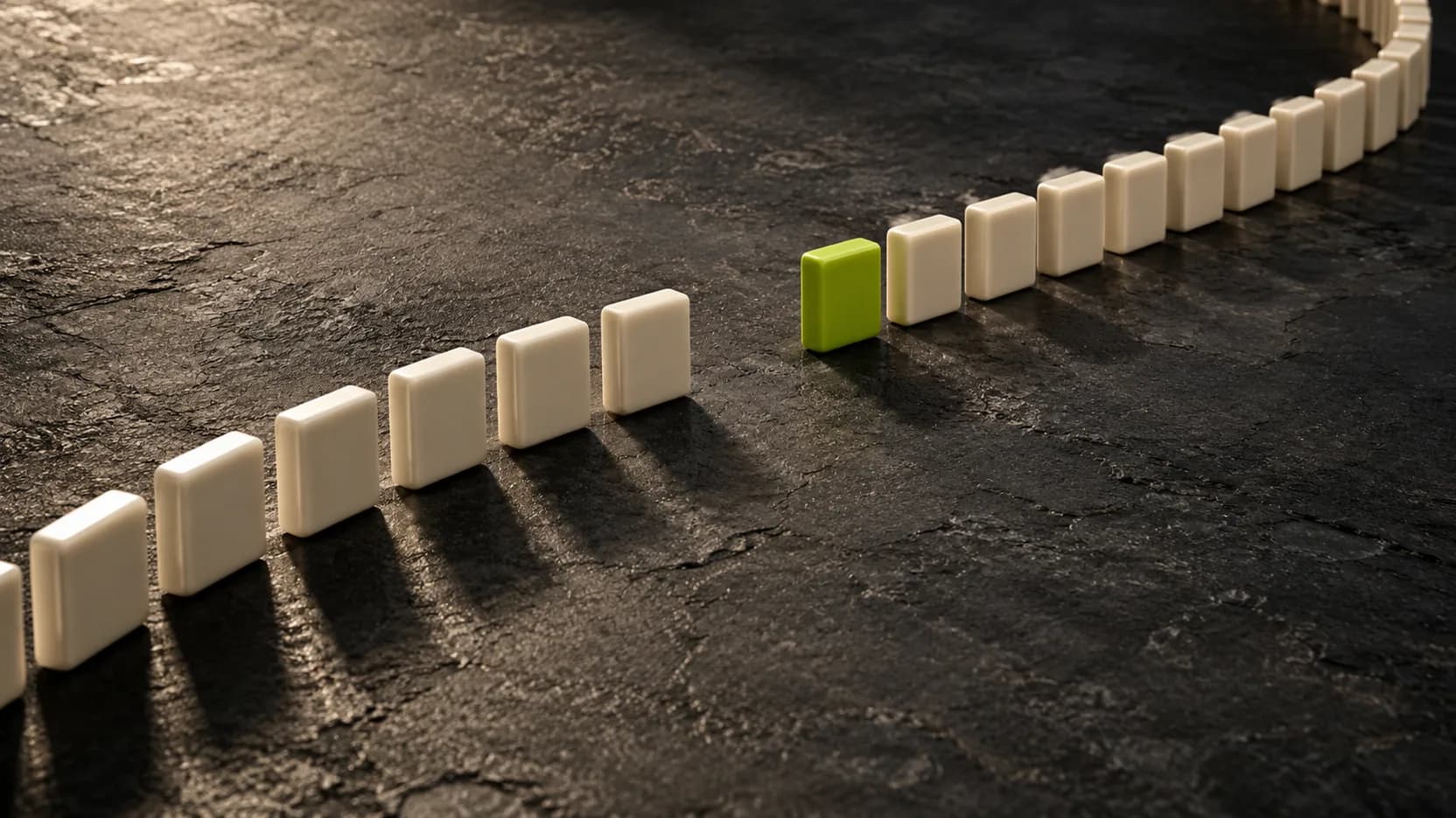 A curved row of ivory ceramic tiles on dark stone, with a gap followed by a lime-green tile and the continuing row